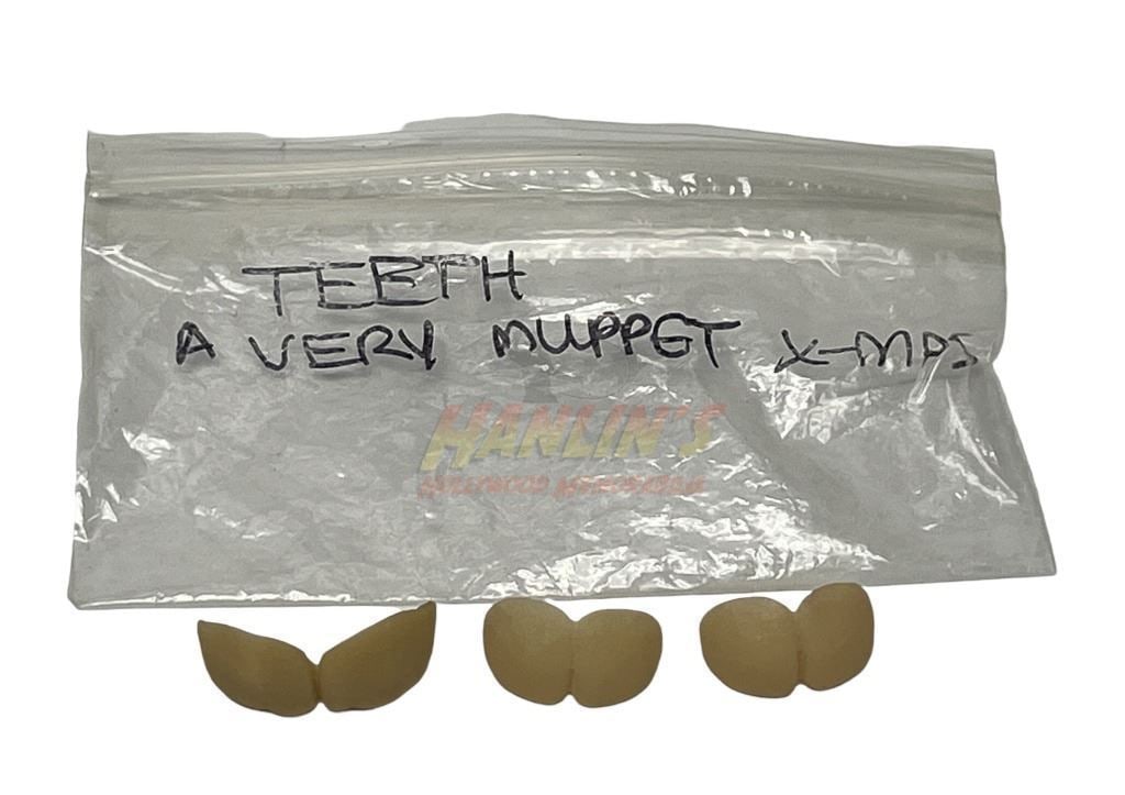 It's a Very Merry Muppet Christmas Movie (2002) Set of Three Whoville Teeth: It's a Very Merry Muppet Christmas Movie (2002) Set of Three Whoville Teeth.Seen when the Muppets are being chased by the Whoville characters.Originally from the Bill Terezakis (special makeup effects