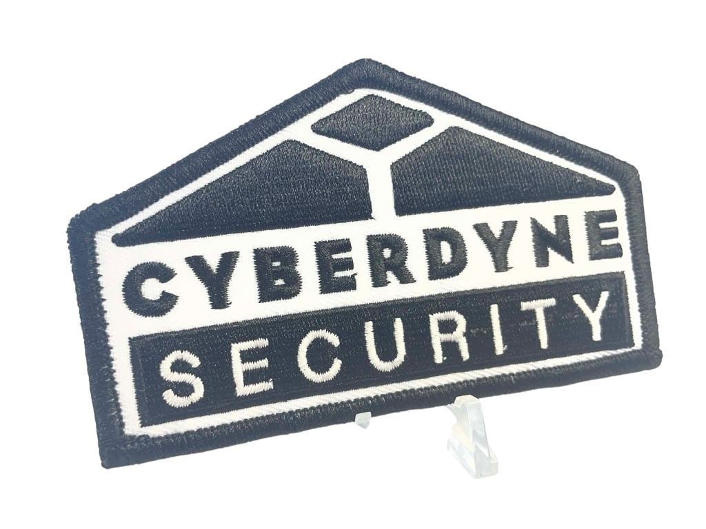 Terminator Genisys (2015) - Cyberdyne Security Patch: Terminator Genisys (2015) - Cyberdyne Security Patch.Original Cyberdyne Security Patch used in the science fiction film 'Terminator Genisys' (2015).Measuring 4" wide.Starring Arnold Schwarzenegger,