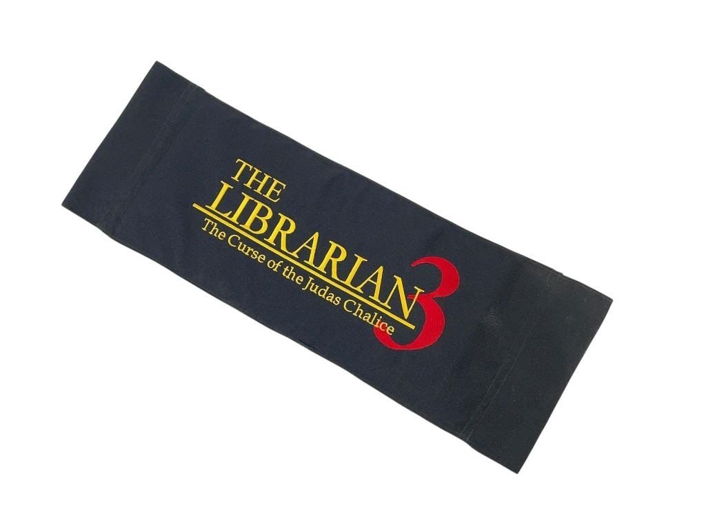 The Librarian III: The Curse of the Judas Chalice (2008) - Chairback: The Librarian III: The Curse of the Judas Chalice (2008) - Chairback.Measuring 8" x 22".Original chairback used in the production of the Jonathan Frakes directed television fantasy-adventure film