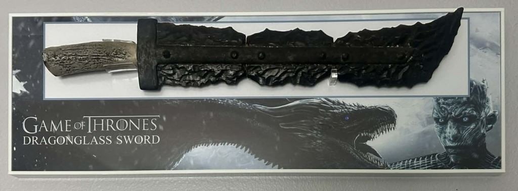 Game of Thrones (2011-2h019) - Dragon Glass Sword With Custom Display: Game of Thrones (2011-2019) - Dragon Glass Sword With Custom Display.Made of hard resin/rubber measuring 25 1/2".Original Dragon glass sword used in the fantasy drama television series 'Game of Throne