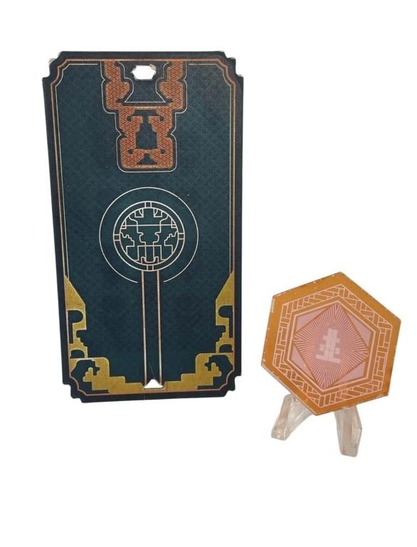 Halo (2022) - Playing Card and Currency Chip: Halo (2022) - Playing Card and Currency Chip.Card made of plastic measuring 2 1/2" x 4 7/8".Chip is made of acrylic measuring 2".Original prop playing card and currency chip used in the production of 