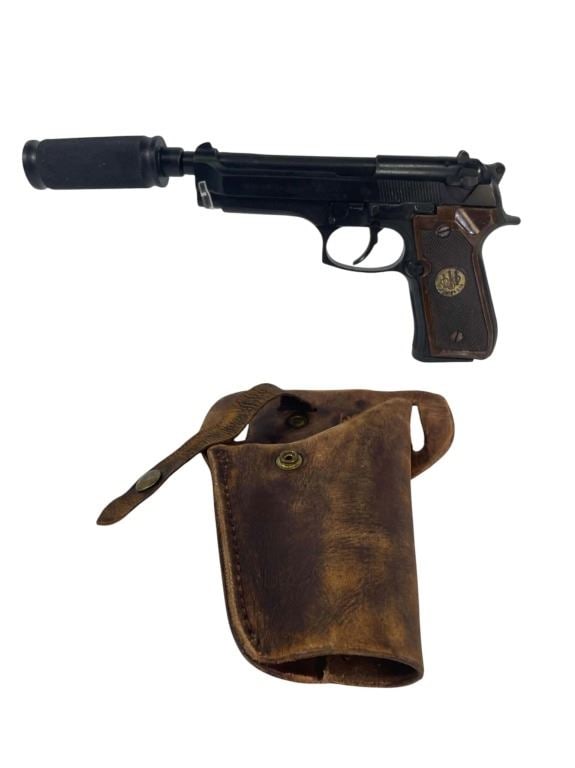 The Walking Dead (2010-2022) - Tara (Alanna Masterson) Beretta 92FS Pistol With Holster: The Walking Dead (2010-2022) - Tara (Alanna Masterson) Beretta 92FS pistol with silencer attachment and Holster.Original stunt Beretta 92FS pistol with silencer attachmen, along with a brown leather p