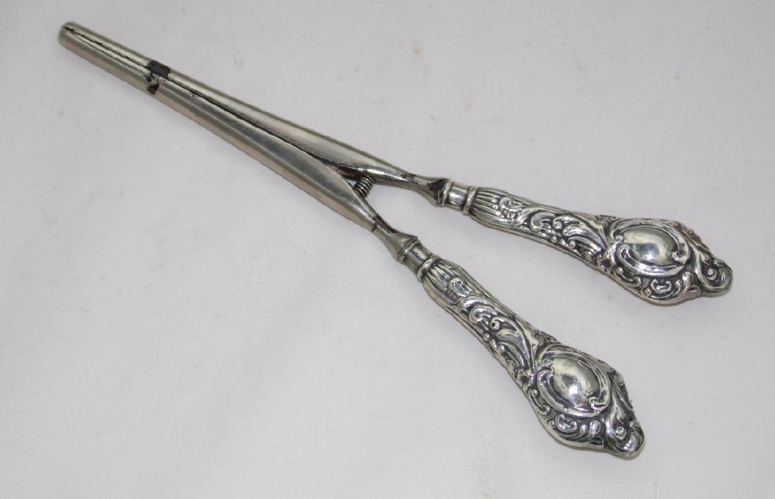 Edwardian Silver Repousse Handled Glove Stretchers: Edwardian Sterling Silver Repousse Handled Glove Stretchers by William Harrison Walter. Hallmarked Birmingham 1906-07. Length 8 inches.