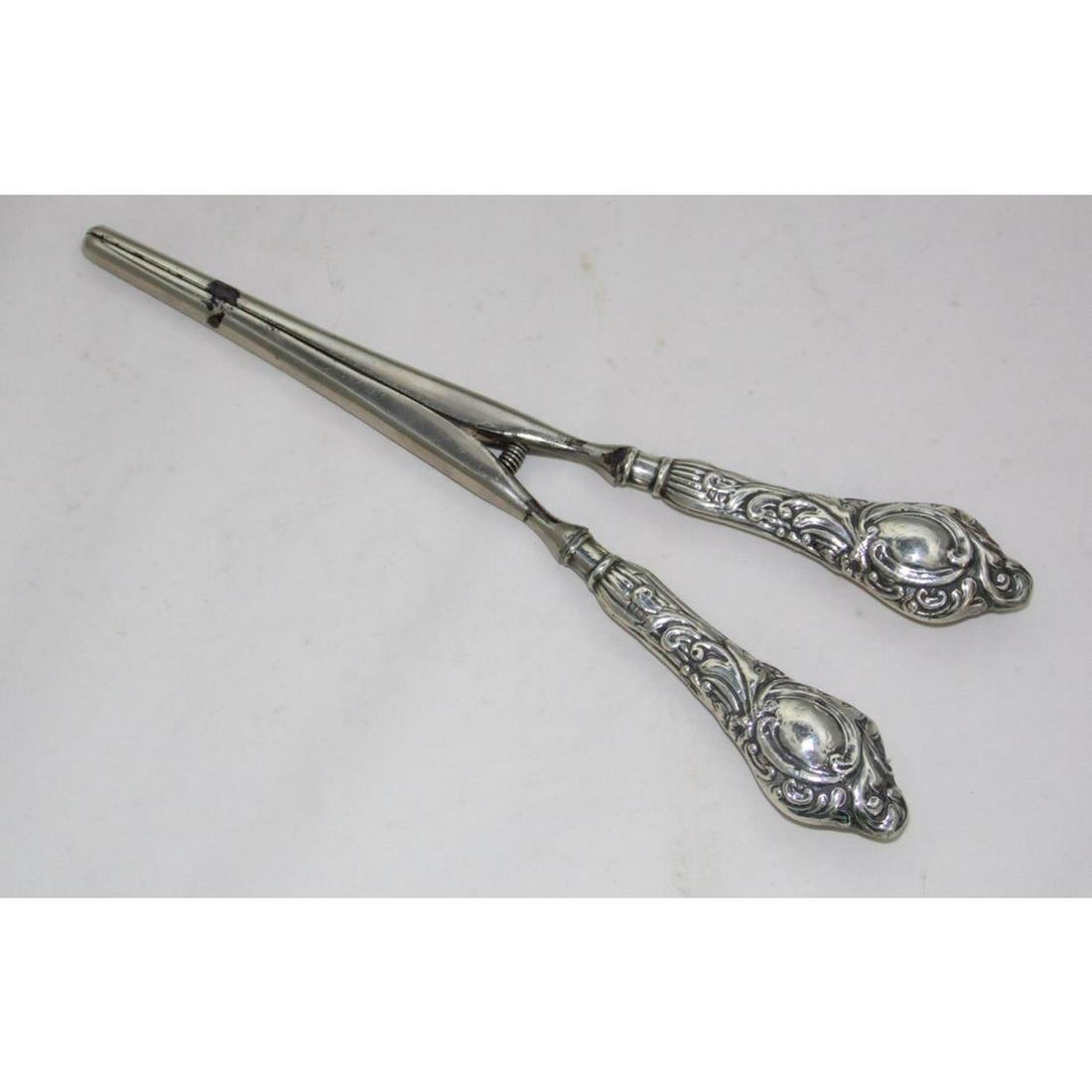 Edwardian Silver Repousse Handled Glove Stretchers: Edwardian Sterling Silver Repousse Handled Glove Stretchers by William Harrison Walter. Hallmarked Birmingham 1906-07. Length 8 inches.