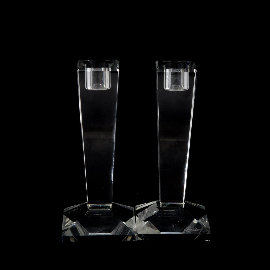 Oleg Cassini etched signature signed Pair of Cut: Pair of cut crystal Modernist design candle stick holders signed Oleg Cassini on base Approx 6.25" h