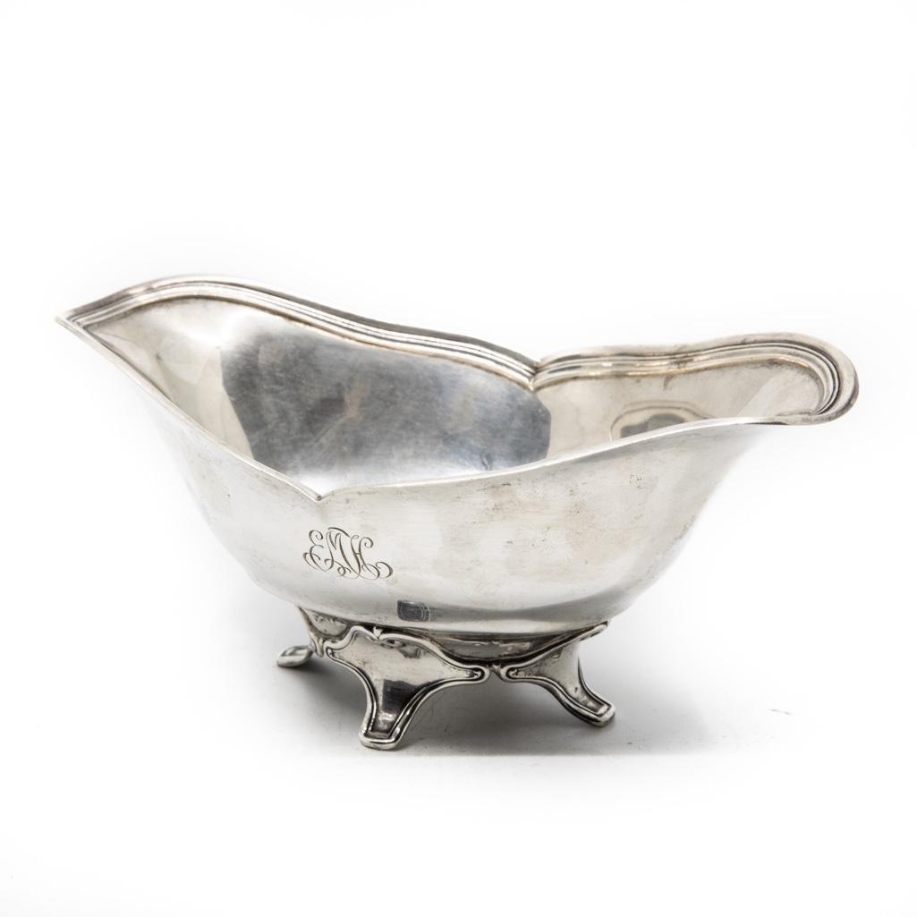 Tiffany & Co. Makers sterling silver (925) sauce boat: Tiffany & Co. Makers sterling silver (925) sauce boat, shaped rim with interior reeding, rising on four supports with scrolled mounts, pattern number 15602, personalized underfoot, approx 3 1/8"h, 7.2