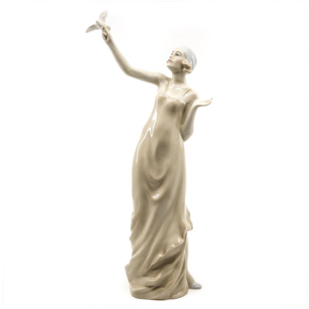 Royal Doulton Ceramic Figurine by Adrian Hughs: Ceramic figure of a woman with a bird in her hand by Adrian Hughs for Royal Dulton 1985 . 13.75"H. 6.5"W x 3.5"D