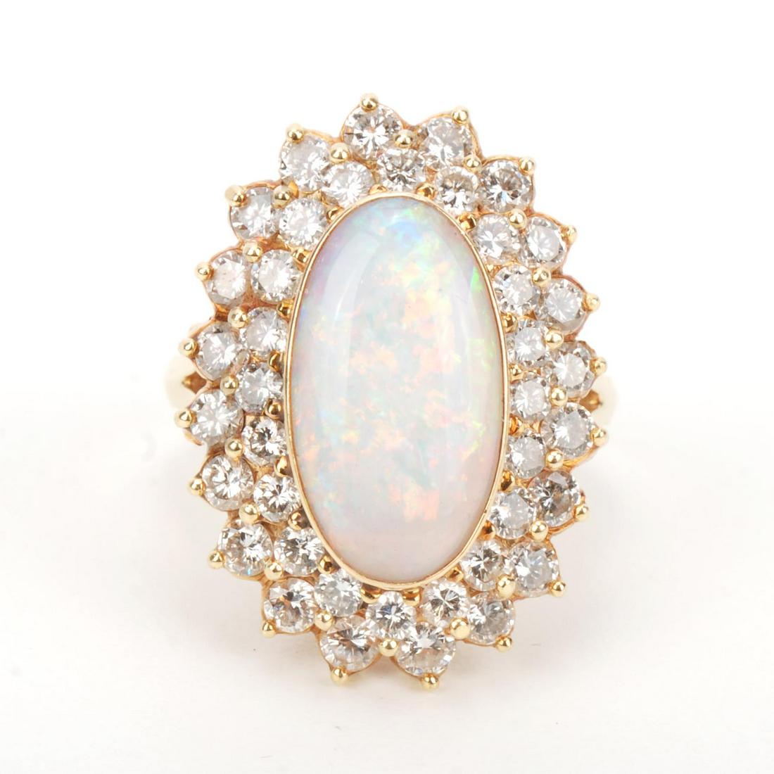 ROSETTE RING WITH DIAMONDS AND OPAL.: Yellow gold with brilliant cut diamonds of a total of approx. 1.40 ct. with central oval cut opal. Ring of 16.5 mm.