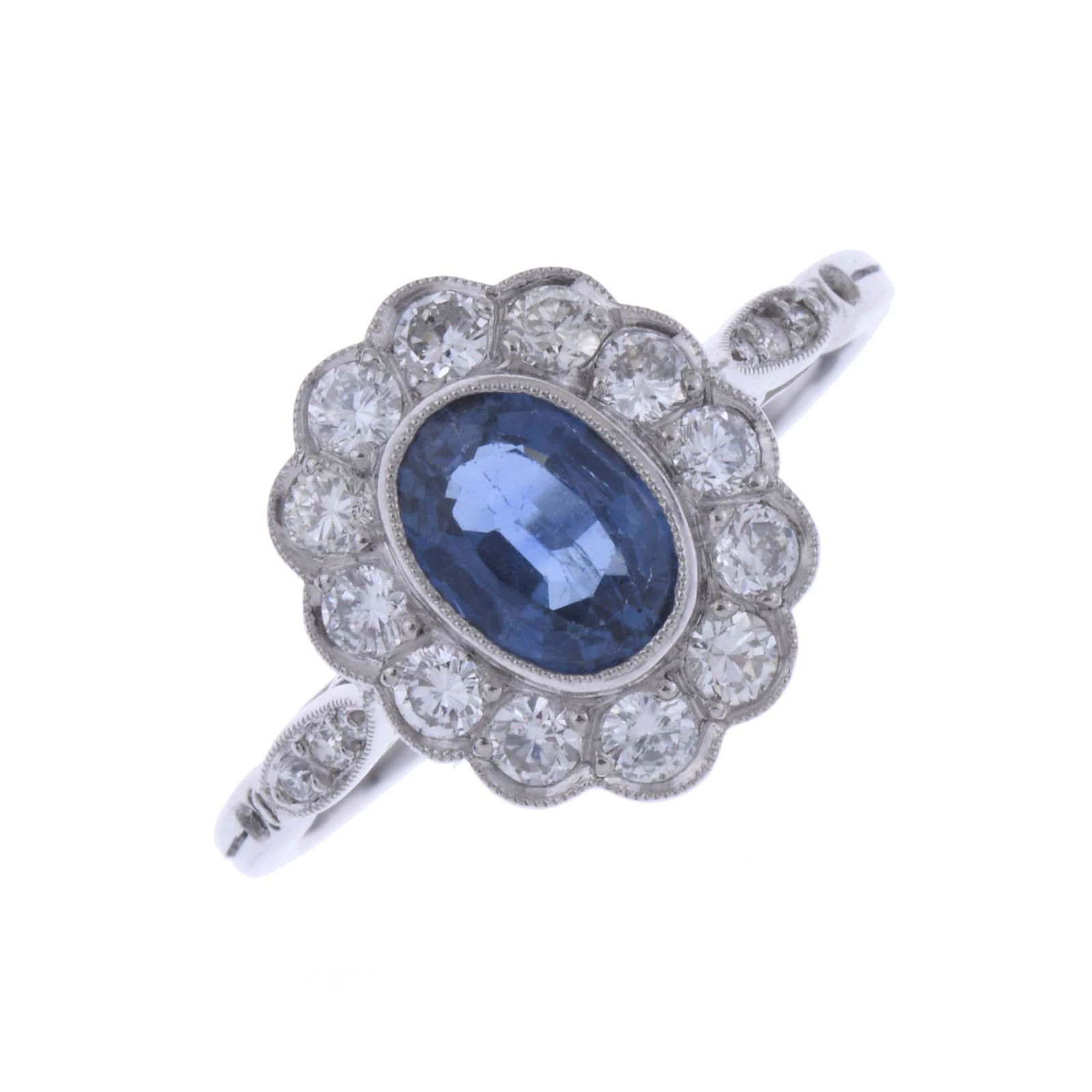 PLATINUM ROSETTE RING.: Platinum with faceted oval sapphire of 6x4 mm and diamonds.