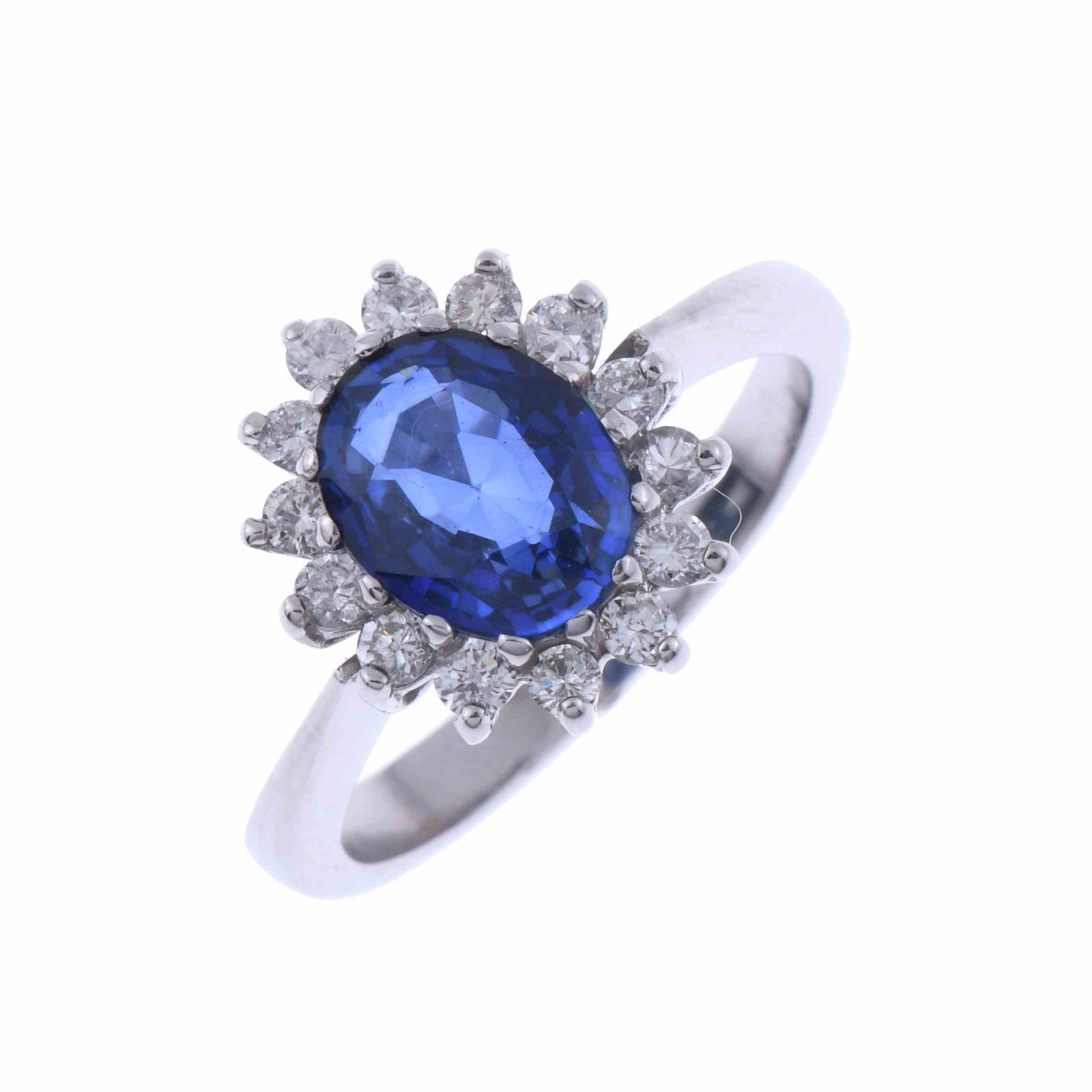 SAPPHIRE AND DIAMONDS ROSETTE RING.: White gold with a central oval cut sapphire measuring 9 x 6 mm, and brilliant cut diamonds of 0.28 ct total weight. Hoop 17 mm. Number 14.