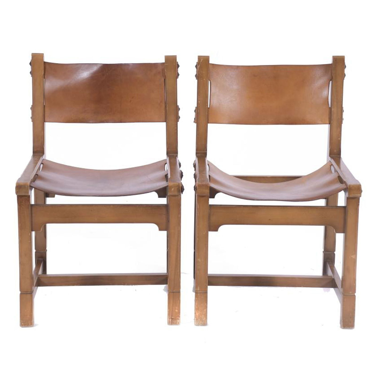PAIR OF CHAIRS, AFTER MODELS BY PIERRE CHAPO (1927 - 1987), CIRCA 1950.: Varnished elm wood and leather. Scuffs on the leather and wear on the wood. 77 x 47.5 x 48 cm.