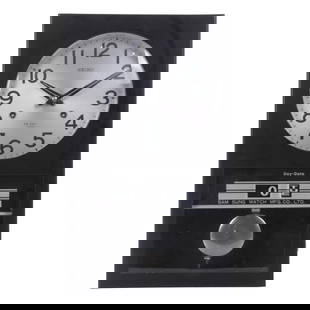 SEIKO. WALL CLOCK, CIRCA 1970.: Rectangular wooden case and metal dial. Arabic numerals. Perpetual date and day of the week below.Hours chiming. Wound for one month.In running order at the time of cataloguing. Key included. 43 x 26