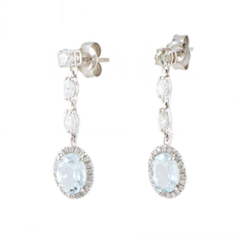 Long earrings with aquamarines, and diamonds rosette.: 18 kt white gold, oval cut aquamarine, and marquise and brilliant cut diamonds.Pressure clasp.Length: 29 mm.