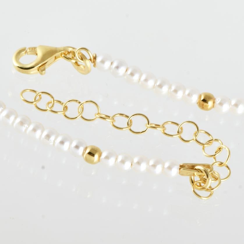 Single-strand choker with imitation pearls.: Gold-plated 925 silver and imitation pearl beads of 2.7 mm. Length when open: 40 cm.