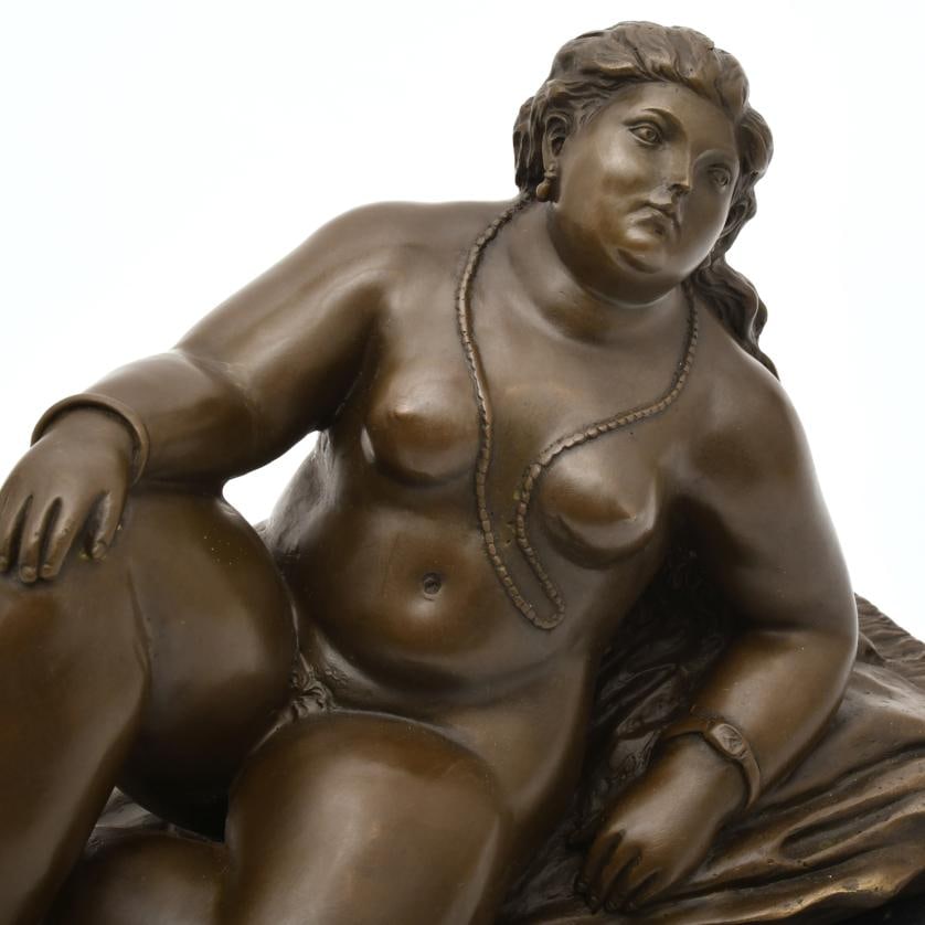 AFTER MODELS BY FERNANDO BOTERO. 'Naked Maja'.: Bronze, with black marble stand. Signature on the base. 18 x 31.5 x 13 cm (without stand); 22 x 33 x 15.5 cm (with stand).