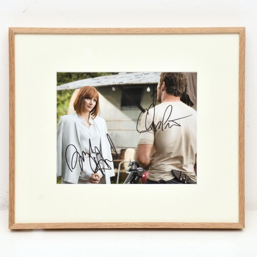 Chuck Zlotnick. Bryce Dallas Howard and Chris Pratt in the film 'Jurassic World'. 2015.: Contemporary colour print. Directed by Colin Trevorrow. Photograph signed by both lead actors. 23 x 25 cm; 35 x 41 cm (frame).