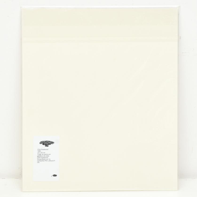 Clint Eastwood. 1983.: Vintage silver gelatin print. Clint Eastwood photographed by Phil Loftus/LFI US. 20 x 15.5 cm (photo).