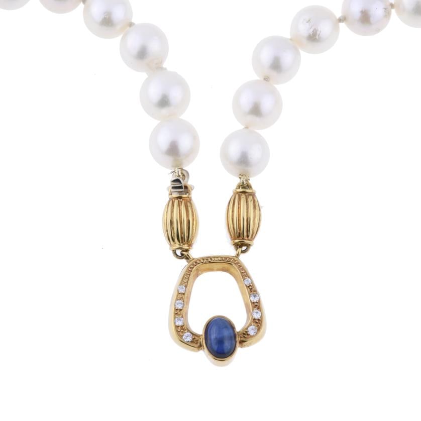 PEARLS NECKLACE.: Cultured pearls with yellow gold clasp in cabochon sapphire and diamonds.
