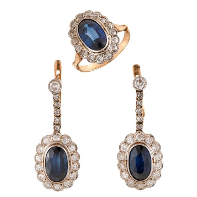 Ring and earrings set with sapphires surrounded by a diamonds rosette.: 18 kt yellow gold. White gold views. Multifaceted oval cut sapphires. Brilliant and old cut diamonds.Long earrings with a Catalan clasp.Ring size 14/54.