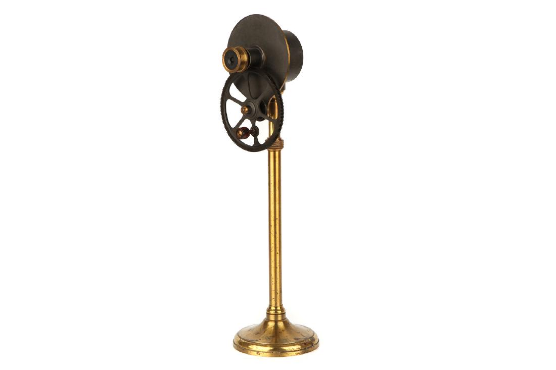 A Jules Duboscq Halo Optical Toy,: French, c.1840, signed to the top 'J Dudoscq a Paris No.10', with large geared wheel with lignum handle driving a small pinion geared tube containing a glass grating behind the eyepiece, on a brass st