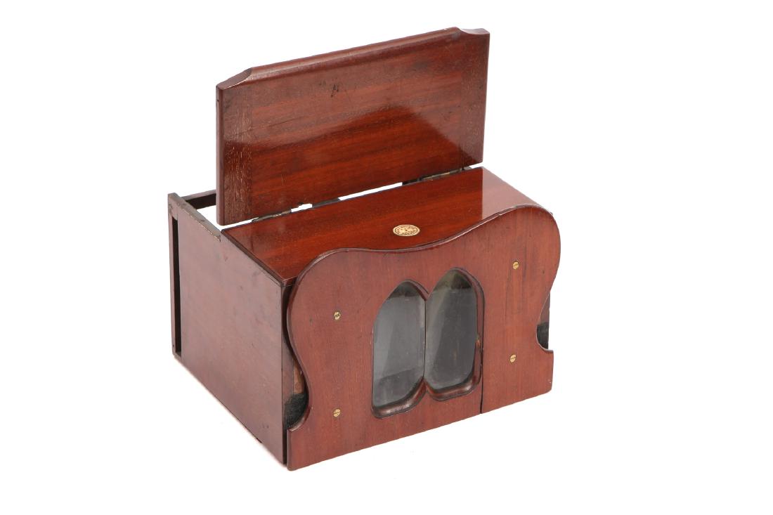 A Knight Cosmorama Type Viewer,: English, c.1860, with plaque to top for 'BY R(Royal) LETTERS PATENT, PEC 774', with gothic arched viewing lenses to front, lift up panel to top with mirror to underside
