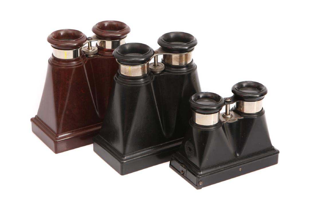 A Collection of Three Bakelite Stereo Viewers,: French, c.1900, one in brown bake lite with the other two in black