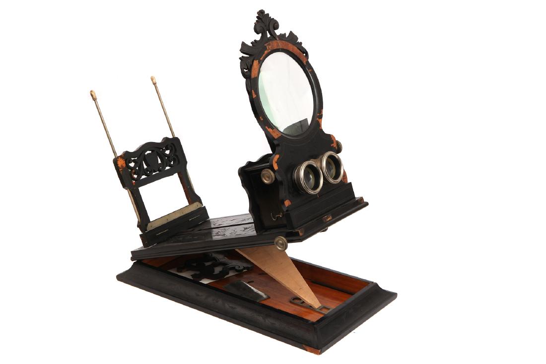 A Large Black & Silver Stereo Graphoscope: English, c.1880, unsigned, finished with a ebony veneer that has perished and cracked with losses, stereo front with fold up viewer housing, with unusual chan drive focus, length 58cm