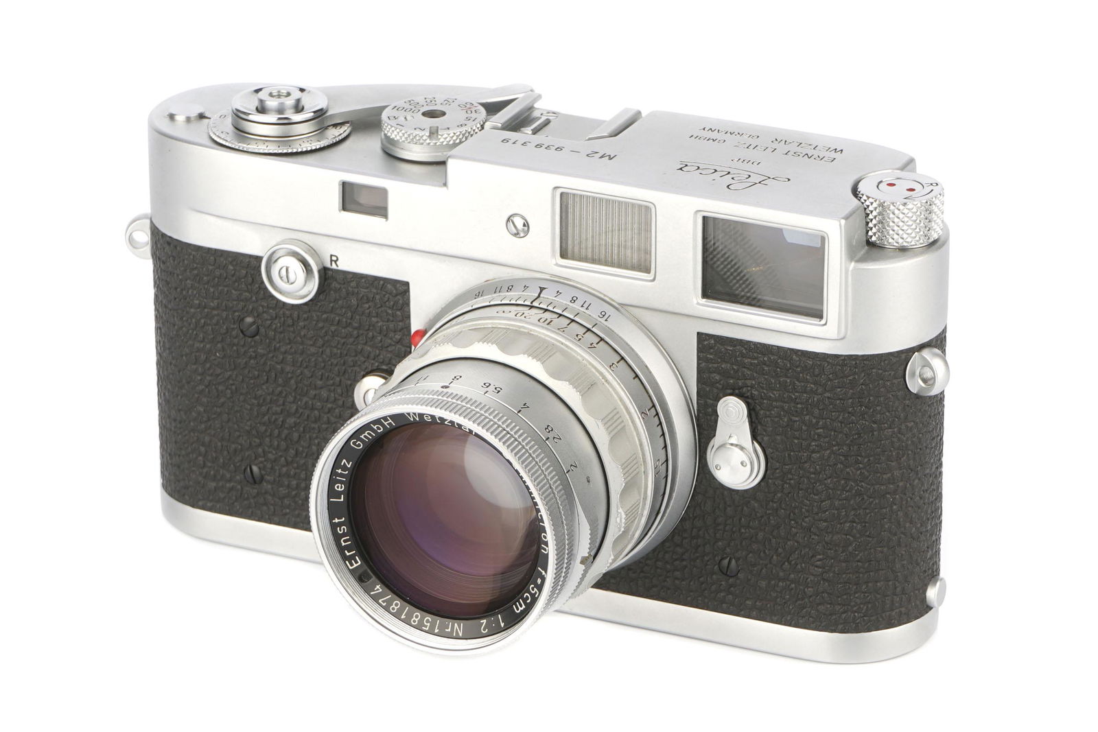 A Leica M2 Rangefinder Camera, : A Leica M2 Rangefinder Camera, 1958, button rewind, chrome, serial no. 939319, with Leitz Summicron f/2 50mm lens, rigid, chrome, serial no. 1581874, body, VG-E, shutter working, curtain sticking on s