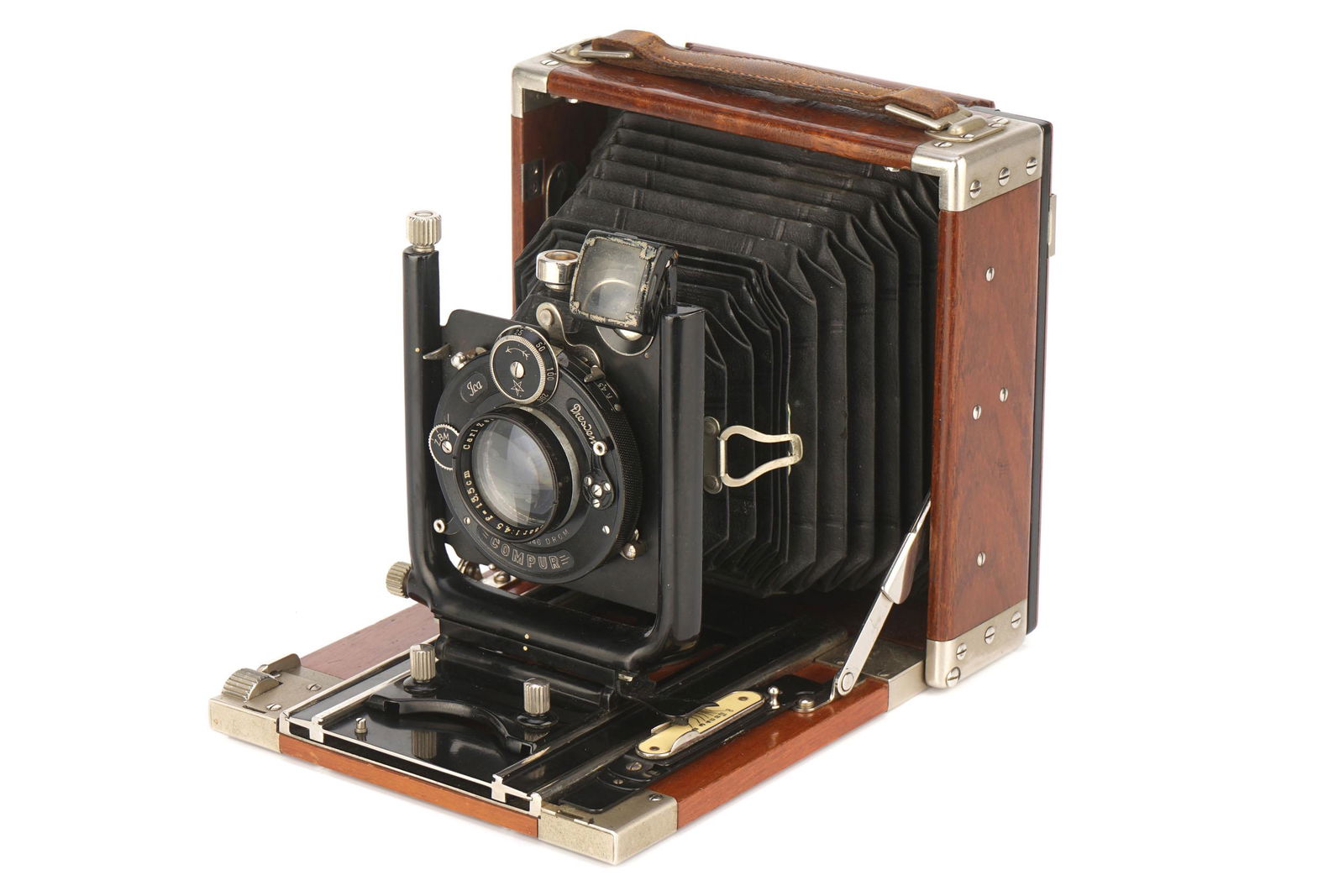 An ICA Favorit (265) Tropical 9x12cm Camera,: An ICA Favorit (265) Tropical 9x12cm Camera, 1915-22, teak, serial no. H82948, with Carl Zeiss Jena Tessar f/4.5 135mm lens, serial no. 496013, body, VG-E, lens, G-VG, some internal marks Note: VAT du
