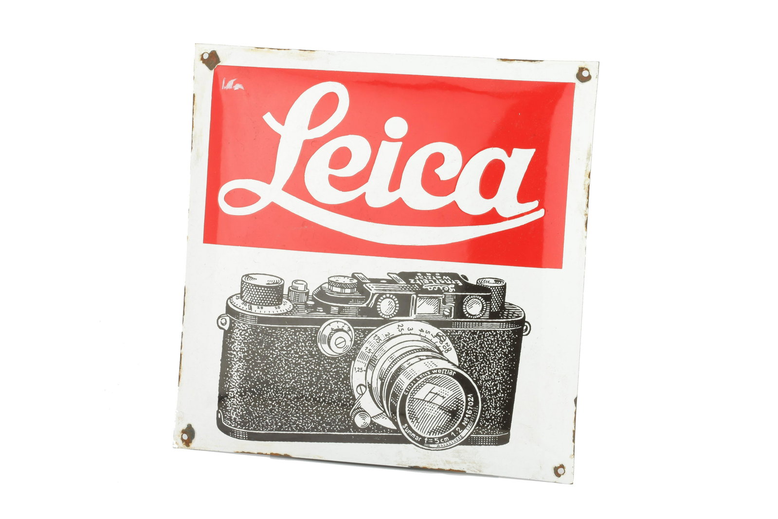 A Leica Advertising Dispaly Sign, 39.5cm x 39.5cm: 39.5 x 39.5cm, convex signel sided enamel Note: Lot imported under Temporary Admission. 5% UK import VAT will be charged on the â€˜hammerâ€™ and 20% UK VAT will be charged on the â€˜buyer