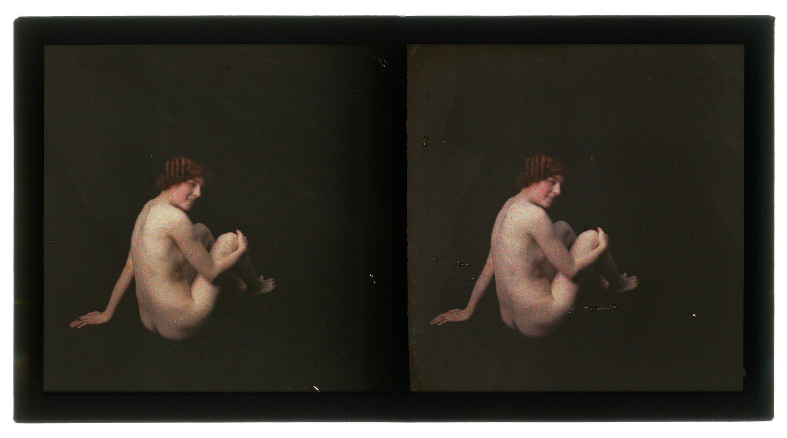 An Erotic Autochrome Stereoview,: c.1920, colour glass plate images of nude with auburn hair seated on the floor, rear view, 12.9cm x 6.8cm