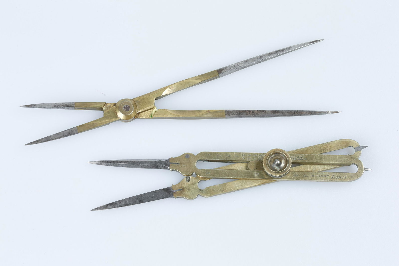 Two Early Pairs of Proportional Dividers,: A pair of adjustable dividers by Thomas Jones, c.1830, with an earlier pair of fixed 1:2 dividersb oth in brass, longest 17cm
