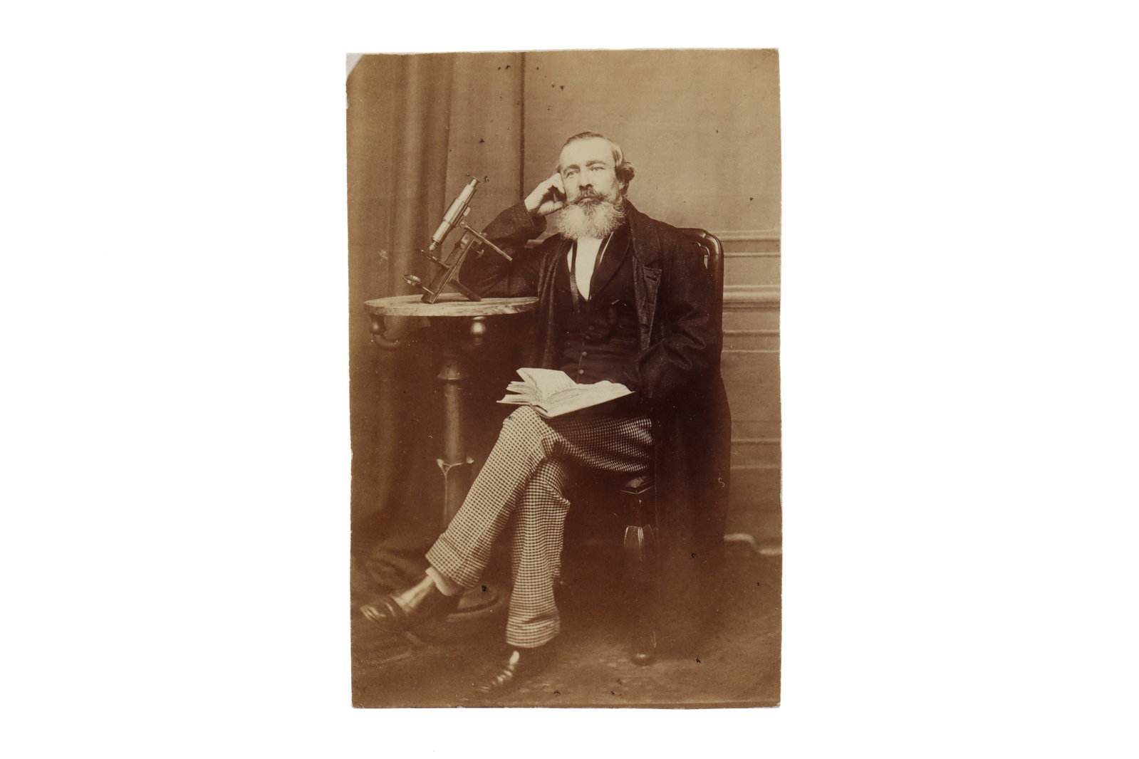 Albumen Print of Dr. Cooper & His Microscope,: Albumen print of a seated gentleman, presumably D.r Cooper, Gurnsey ( as written to the reverse) seated next to an example of Warrington's Universal Microscope Footnote: Warringtons Universal Microsco