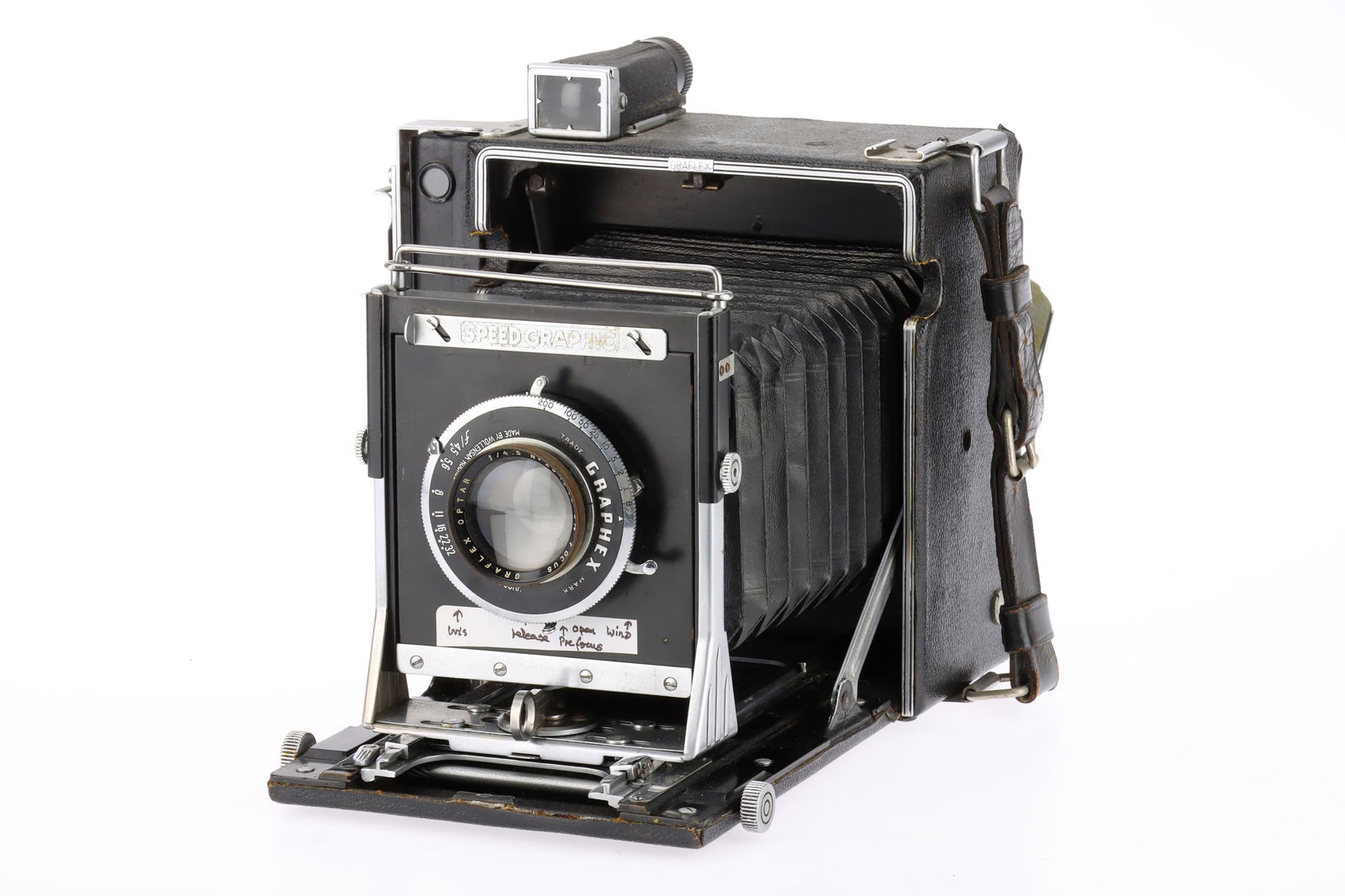 An Anniversary Speed Graphic Large Format Folding Press Camera: black, circa 1945, serial no.322554, made by Folmer-Graflex, with a Graflex Optar f/4.5 6?in. lens, serial no.294868, Wollensak shutter slow speeds sticking, focal plane shutter working, body F, rear