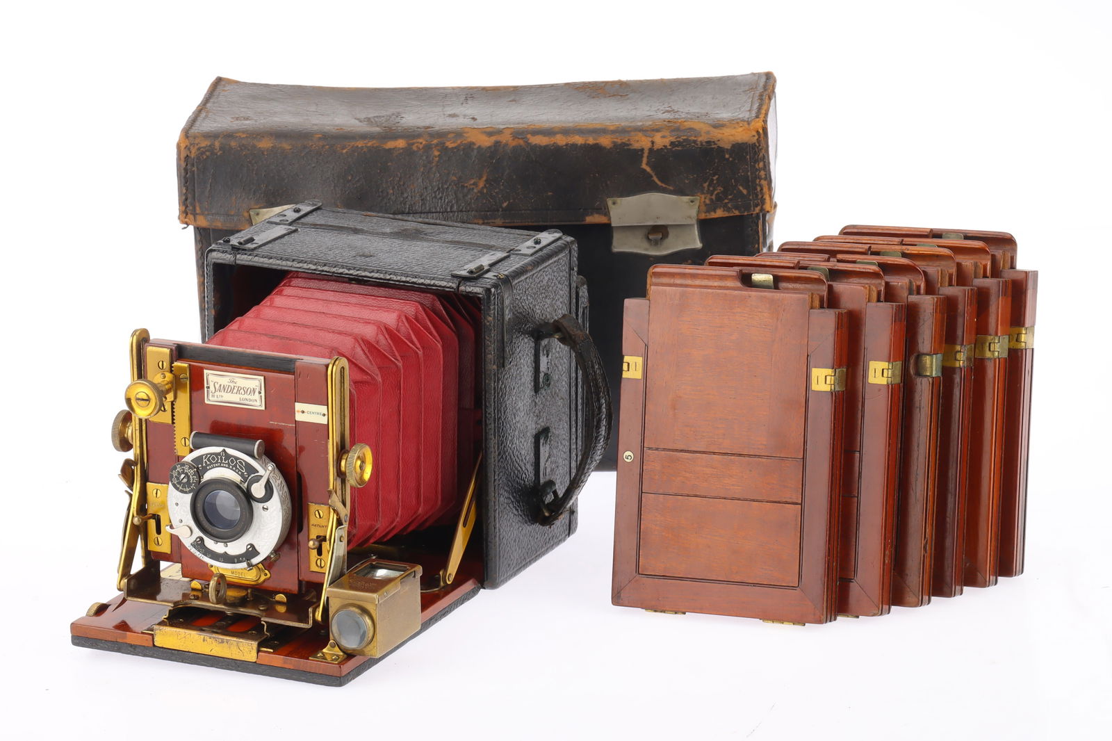 A Sanderson Hand and Stand Folding Camera,: black leather, body G, red bellows extend correctly, not light tested, prism finder clear, with a Goerz f/6.8 125mm lens, optics F-G, in a Koilos shutter, working, with 6 plate holders, in a rigid lea