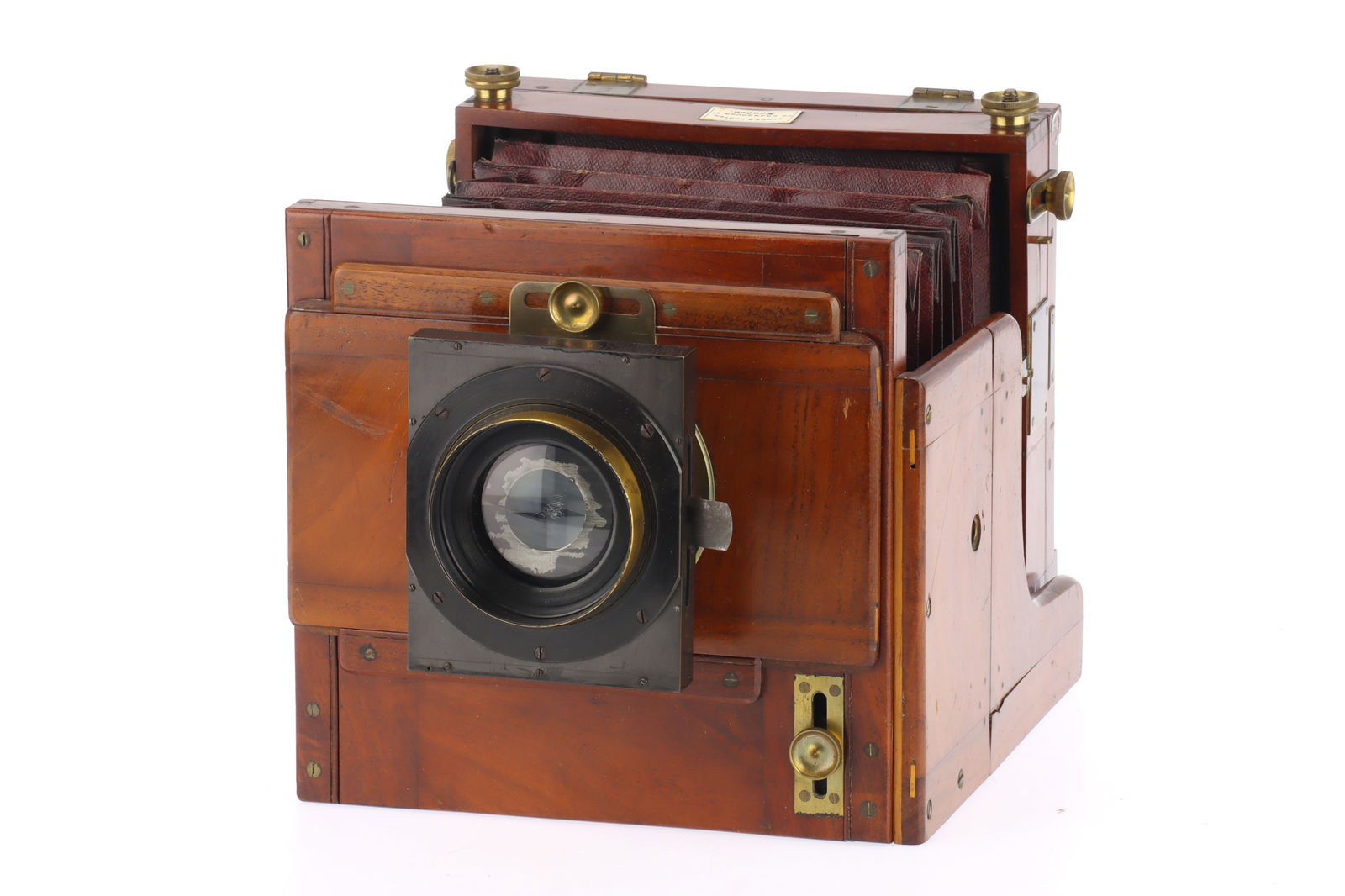 A Sands & Hunter Tailboard Camera Square Bellows Half Plate Mahogany & Brass Tailboard Camera,: A Sands & Hunter Tailboard Camera Square Bellows Half Plate Mahogany & Brass Tailboard Camera, body F-G, ground glass VG, bellows require attention, together with an unmarked brass lens, with aftermar