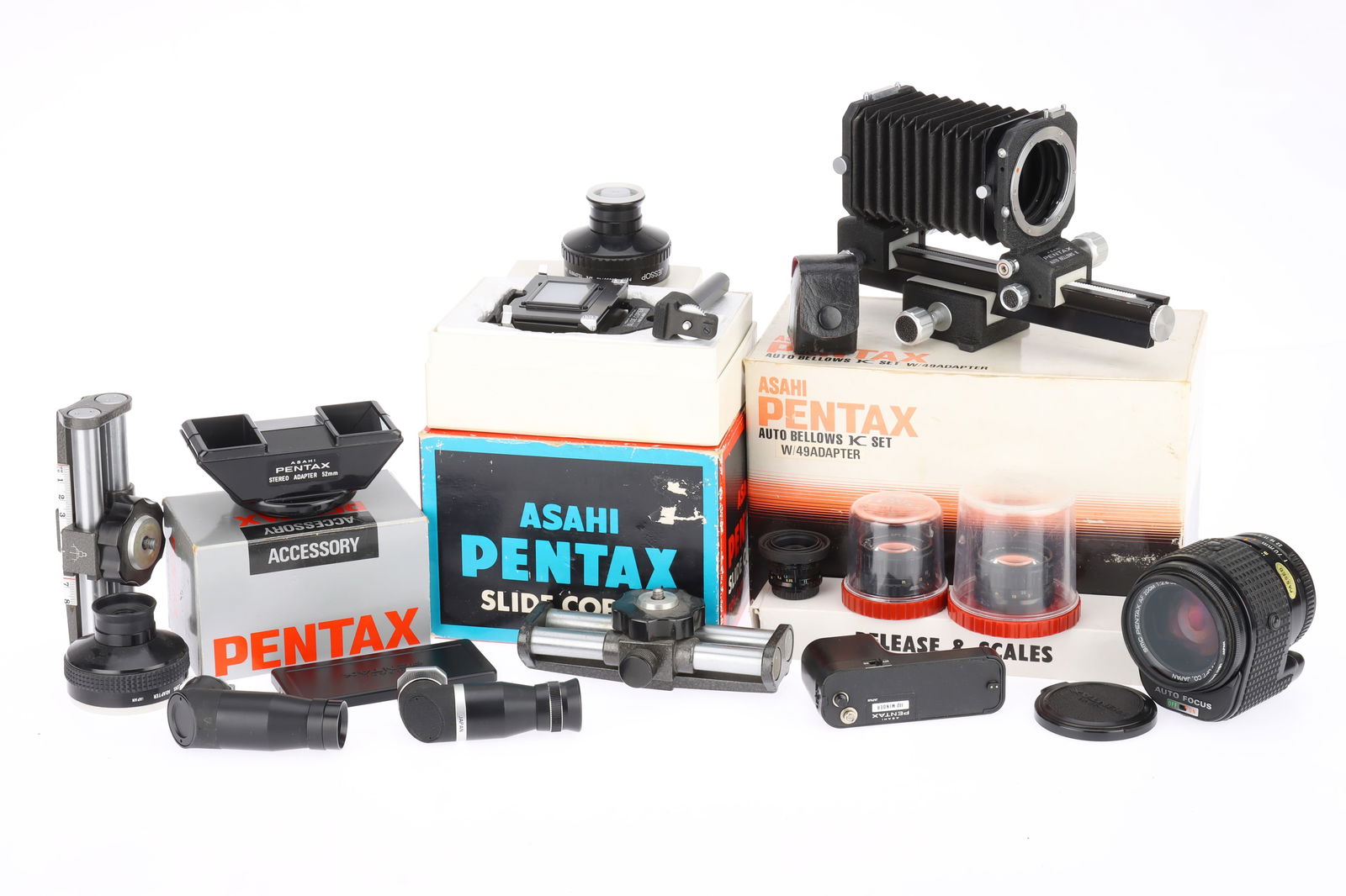 A Selection of Pentax Related Photographica: A Selection of Pentax Related Photographica to include an auto bellows K set, a slide copier, an SMC PentaxAF zoom f/2.8 35-70mm lens, untested, three lenses for Pentax auto-110, a stereo lens attachm