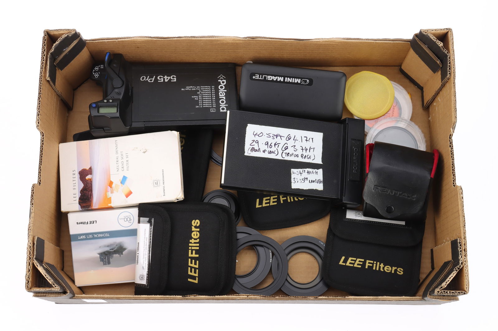 Lee Filters and Polaroid Film backs: Lee Filters and Polaroid Film backs comprising a selection of Lee 100x100mm filters including 0.9ND, 81A, 6Pt Star, a Circular Polariser, a bellows filter holder, a boxed Neutral Density Grad Soft fil