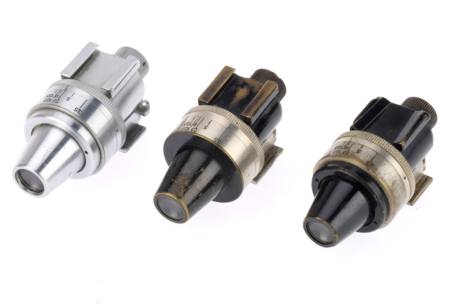 A Trio of Leitz Wetzlar Shoe Mounted Universal Finders,: A Trio of Leitz Wetzlar Shoe Mounted Universal Finders, two in black, one in silver, condition G with some paint wear, optics F-G,