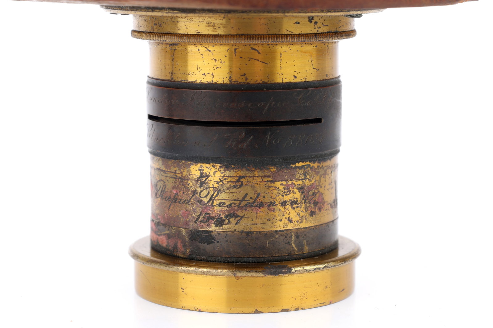 A Londons Stereoscopic Co. 7x5 Rectilinear Lens,: A Londons Stereoscopic Co. 7x5 Rectilinear Lens, brass, barrel G, optics F-G with a little haze, with front cap and wooden flange, lens diameter 30mm, barrel length 65mm.