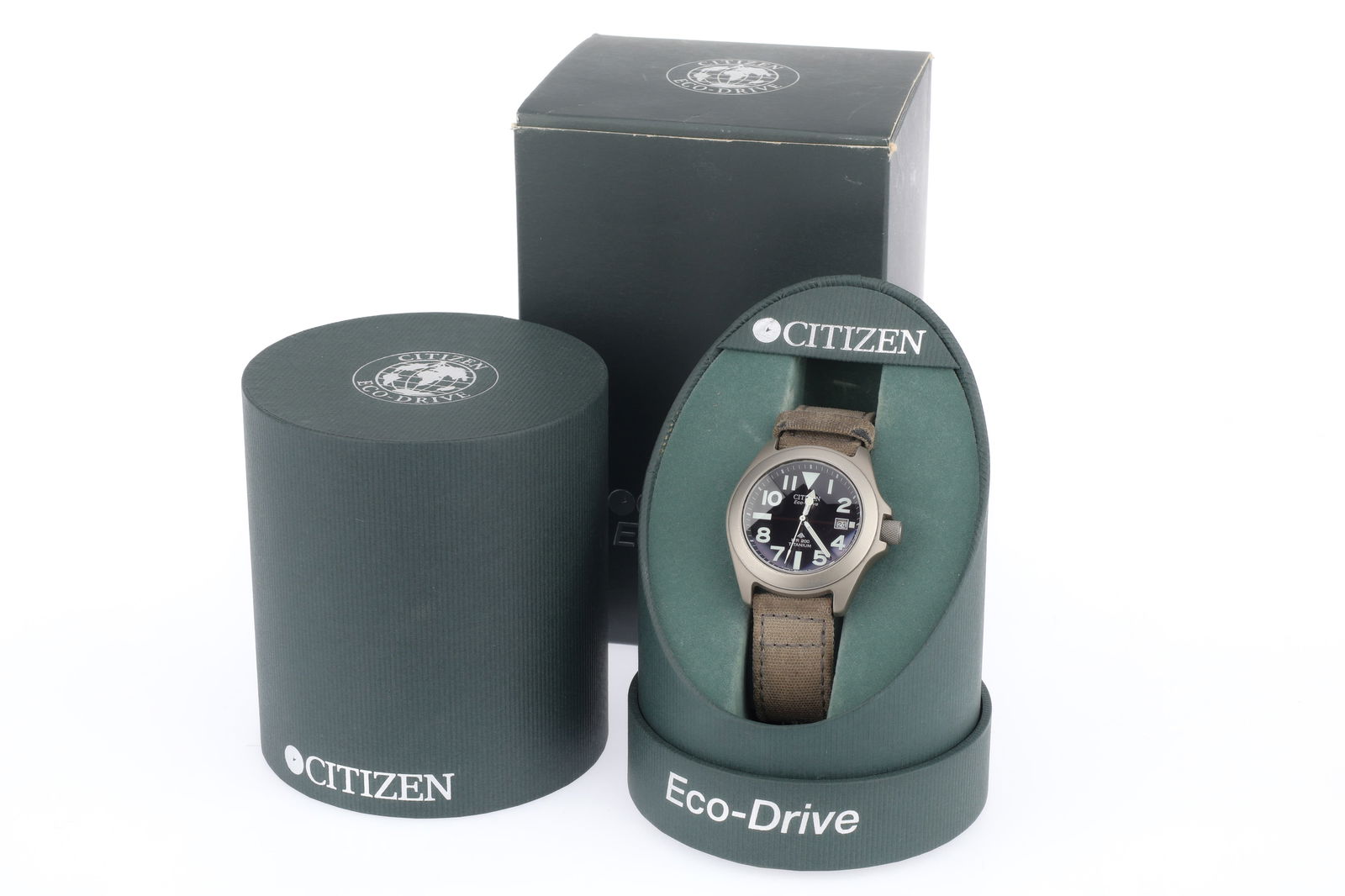 A Citizen Eco-Drive Gents Watch,: A Citizen Eco-Drive Gents Watch, comprising a Citizen Eco-Drive 7828-H09971, black bezel, G, with grey canvas Ritche bracelet, in maker's packaging and box.