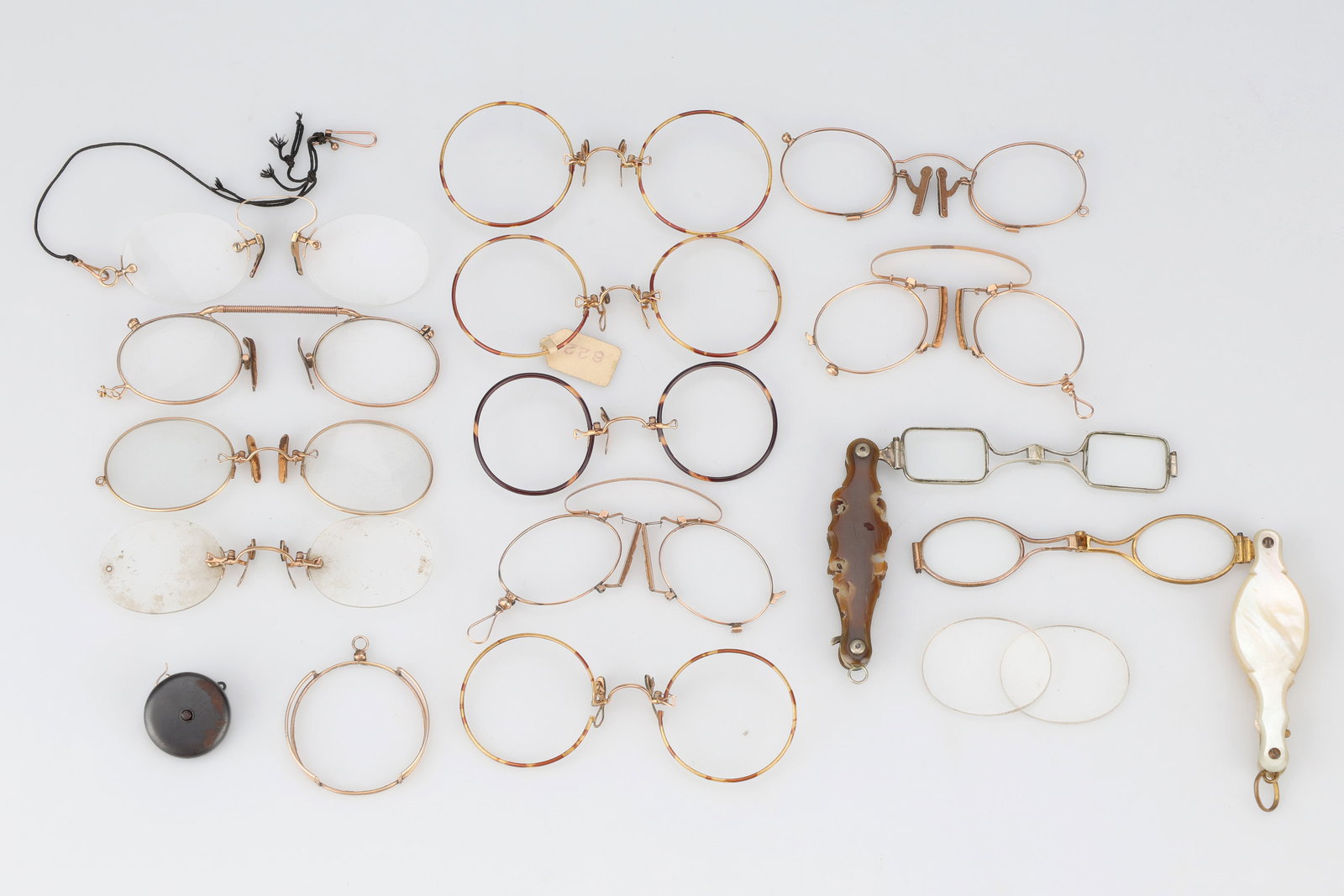 A Group of Lorgnettes and Pince-Nez,: including: a late 19th Century spring-loaded, folding semi-lorgnette with short tortoiseshell handle/guard (pieces missing) and oblong lenses; a similar semi-lorgnette, with mother-of-pearl handle/gua