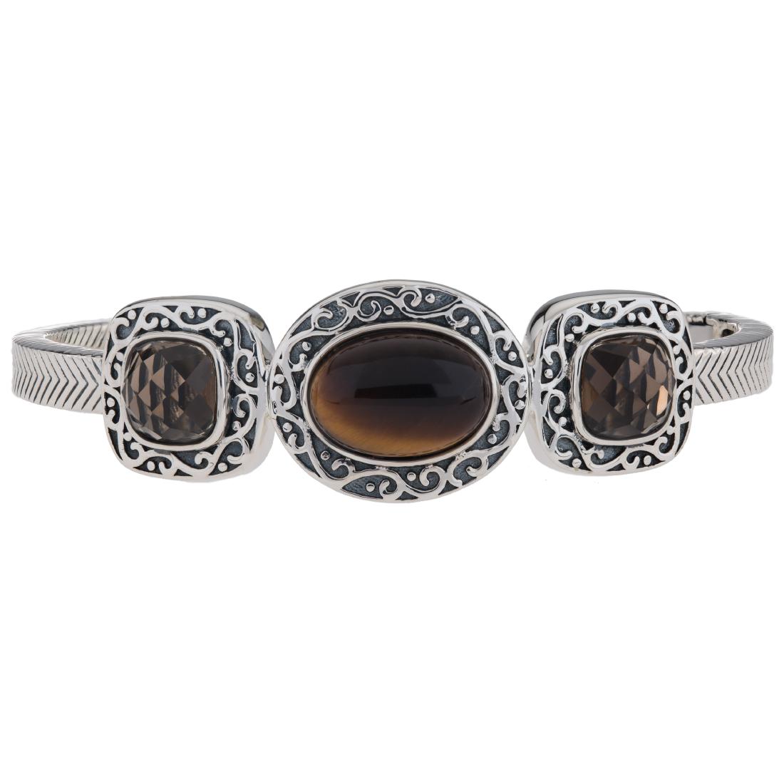 Smoky Quartz and Tiger Eye Hinged Cuff Bracelet: 925 Sterling Silver Pangea Mines fashions the ideal accessory with this beautifully crafted oxidized sterling silver bracelet. Styled with a convenient hinged design and adorned with genuine smoky qua