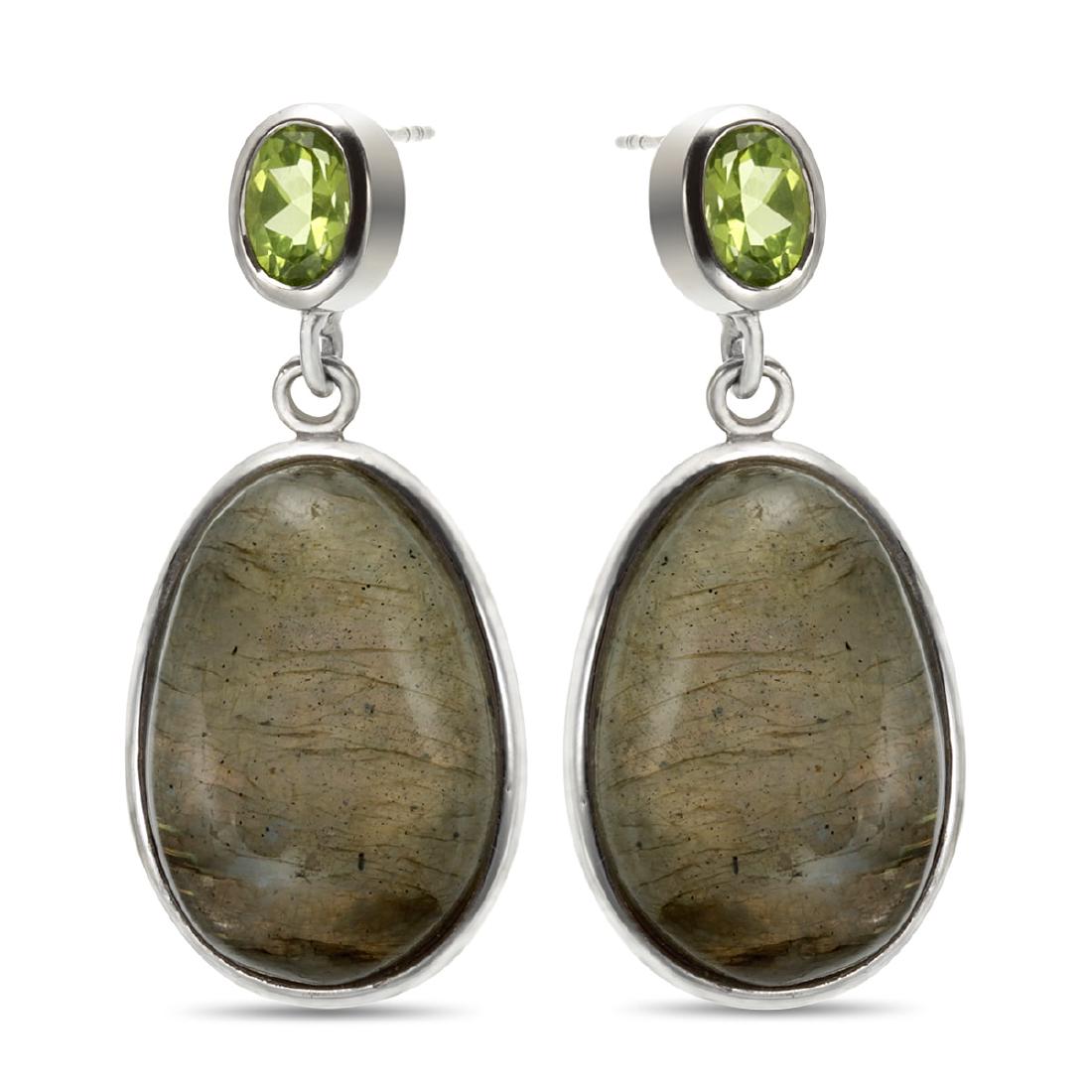 Sterling Silve Oval Labradorite & Peridot Earrings: Crafted in rhodium over sterling silver, each earring in this charming pair features one large oval labradorite cabochon at the center of the dangle. One oval cut faceted peridot decorates the post an