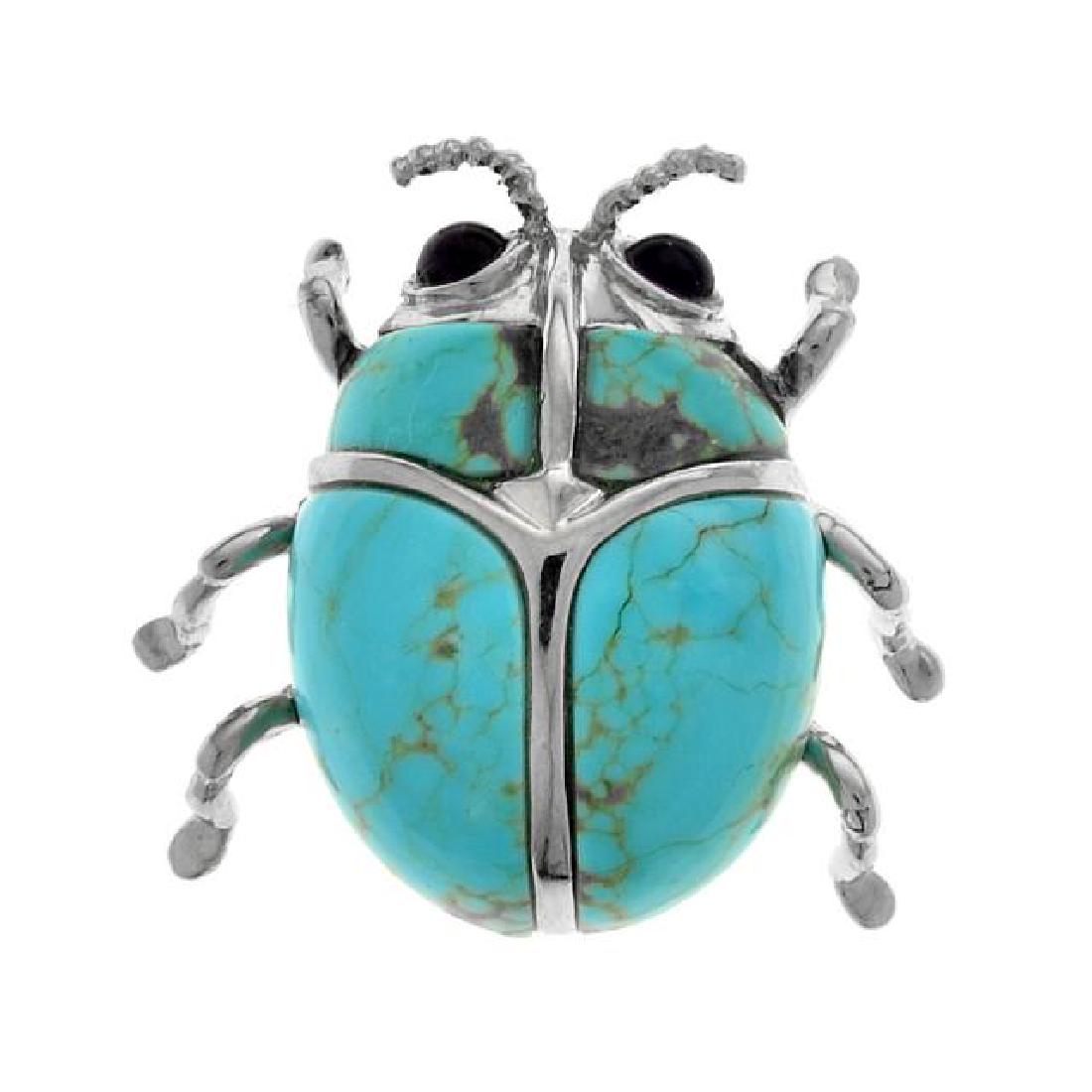 Sterling Silver Turquoise Beetle Pin/ Pendant: • Genuine Turquoise • Crafted in the shape of a beetle • Dual wear as pin or pendant • Gleaming rhodium over fine sterling silver