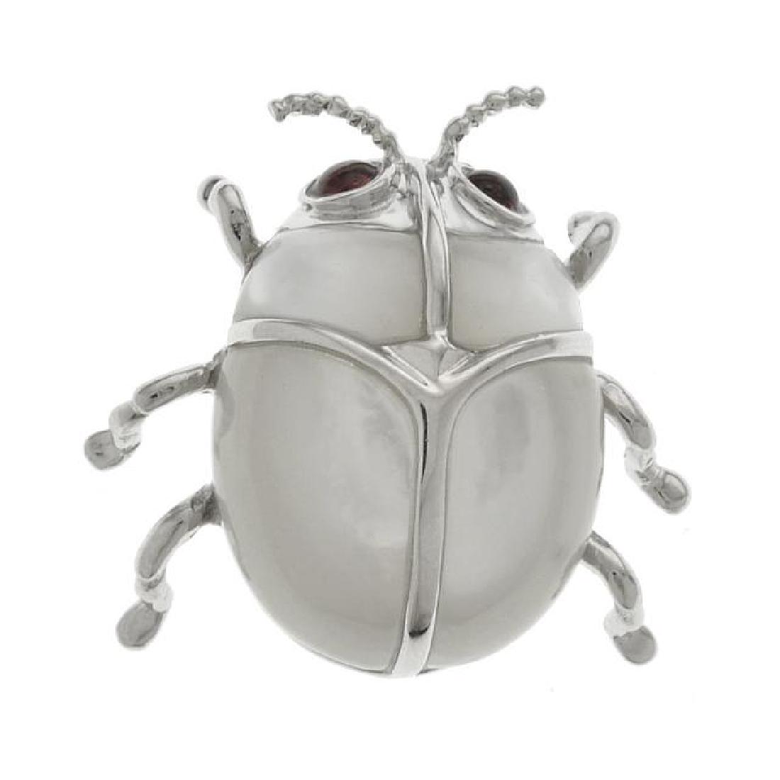 Sterling Silver White MOP Beetle Pin/ Pendant: • Genuine white Mother of Pearl • Crafted in the shape of a beetle • Dual wear as pin or pendant • Gleaming rhodium over fine sterling silver