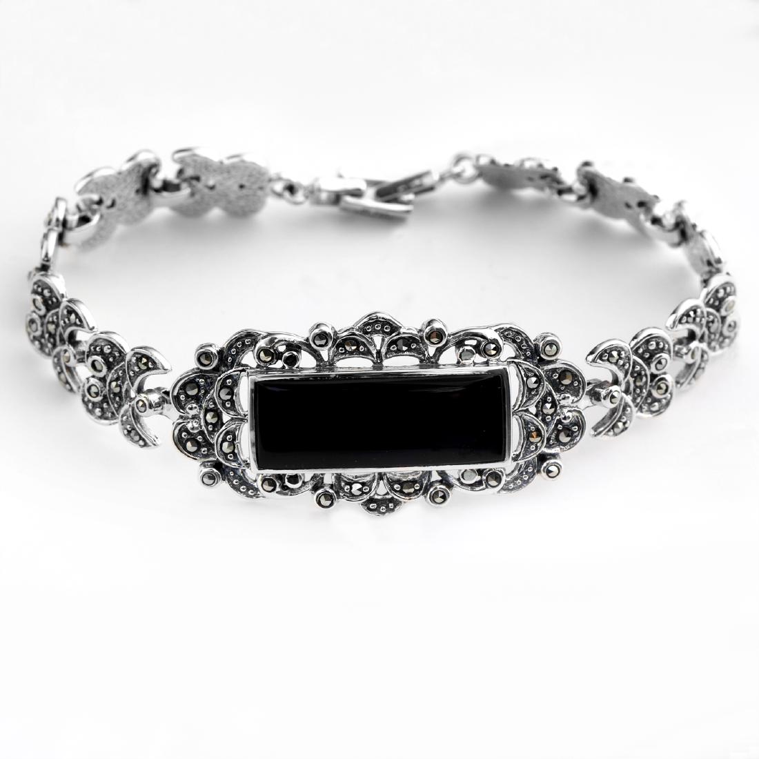 Silver Black Onyx & Marcasite Bar Bracelet: • Genuine black onyx & marcasite • Slide insert clasp for secure fit • 7.2 inch length • Gleamingrhodium over Fine sterling silver