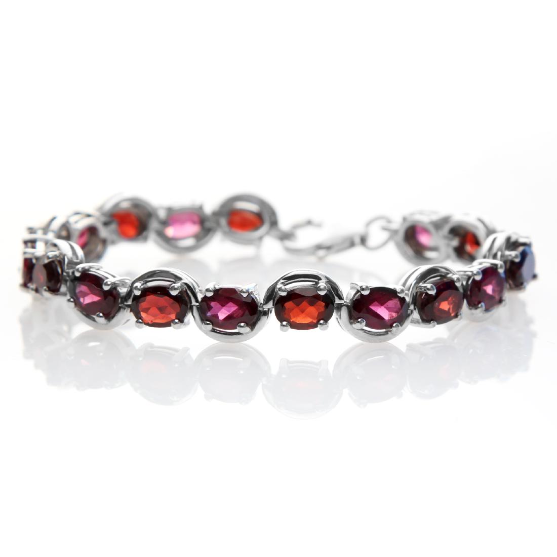 Sterling Silver 6.5" 14.48ctw Garnet Line Bracelet: • Genuine mozambique & rhodolite garnet • 14.48cwt mozambique & rhodolite garnet • 6.5 inch length • Lobster clasp • Gleaming rhodium over fine sterling silver