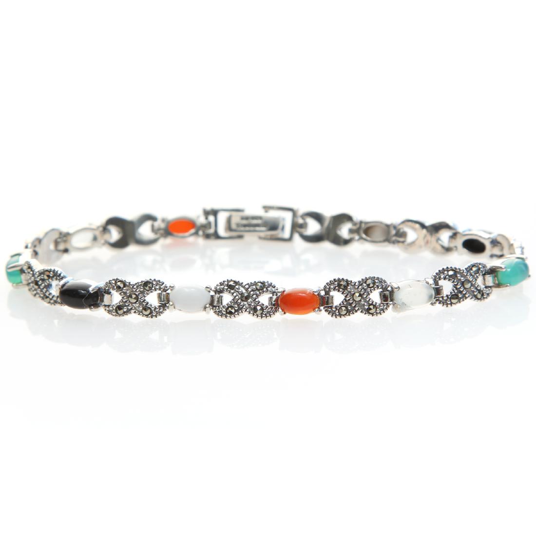Silver 7" Multi Agate & Marcasite Line Bracelet: • Genuine multi color agate • Marcasite stationed in an infinity design between each agate • 7 inch length • Open box clasp • Gleaming rhodium over fine sterling silver