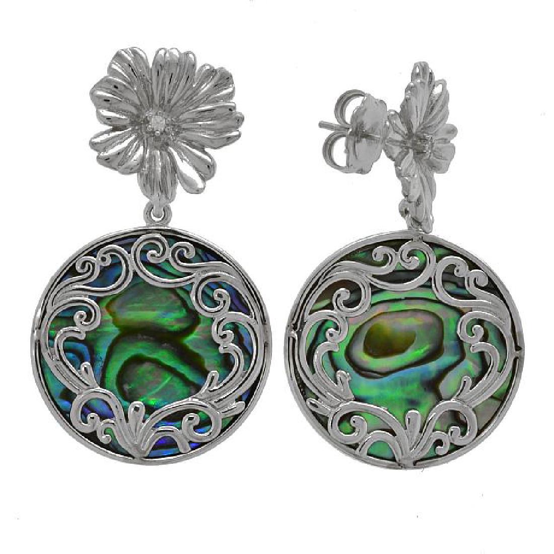 Silver Abalone Scrollwork Overlay Flower Earring: • Genuine abalone • Flower post with stone covered in a scrollowrk overlay • Butterfly backings for comfortable fit • Gleaming rhodium over fine sterling silver